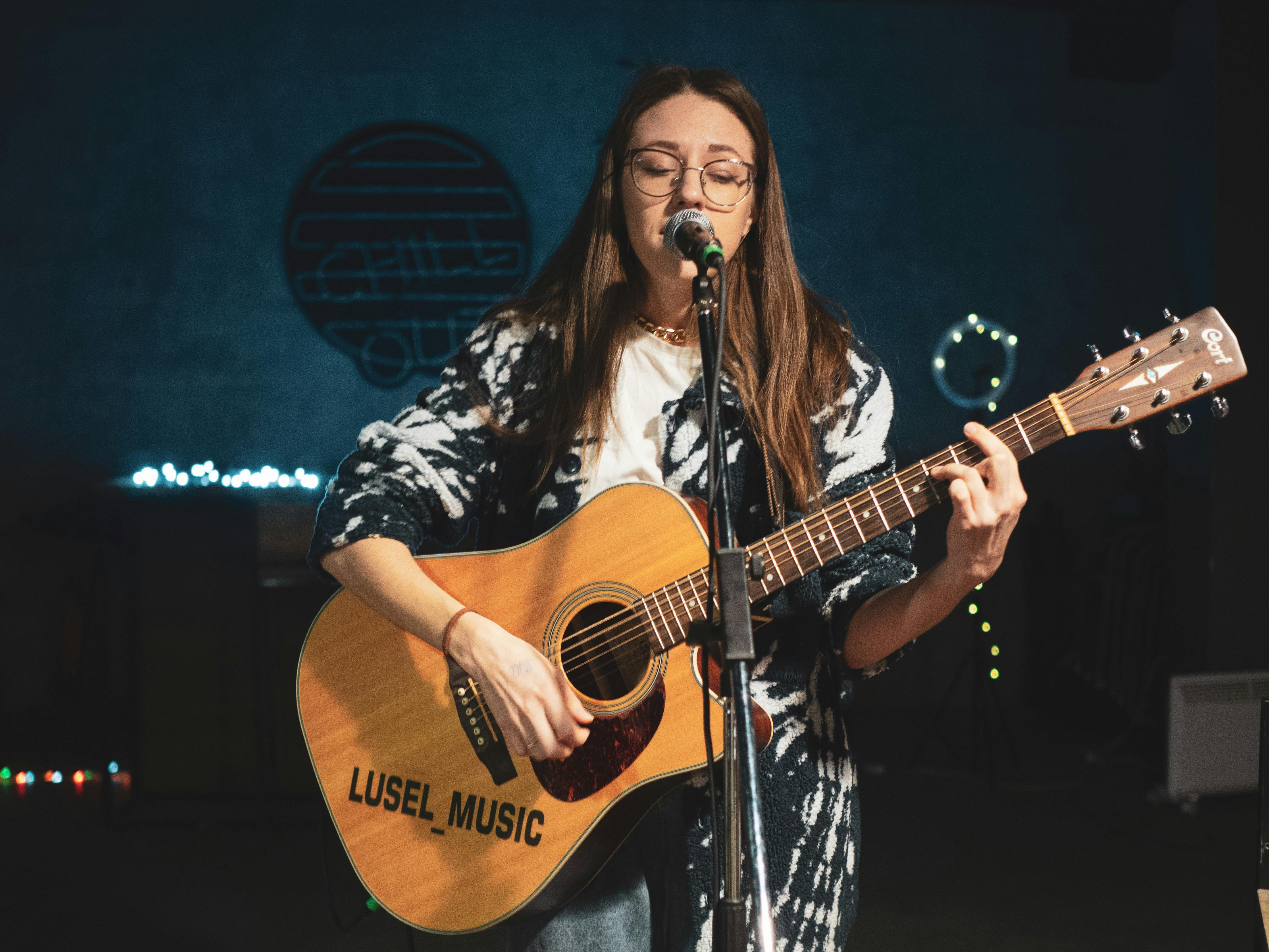 Female acoustic guitarist and singer performing at Savanna's Songfest